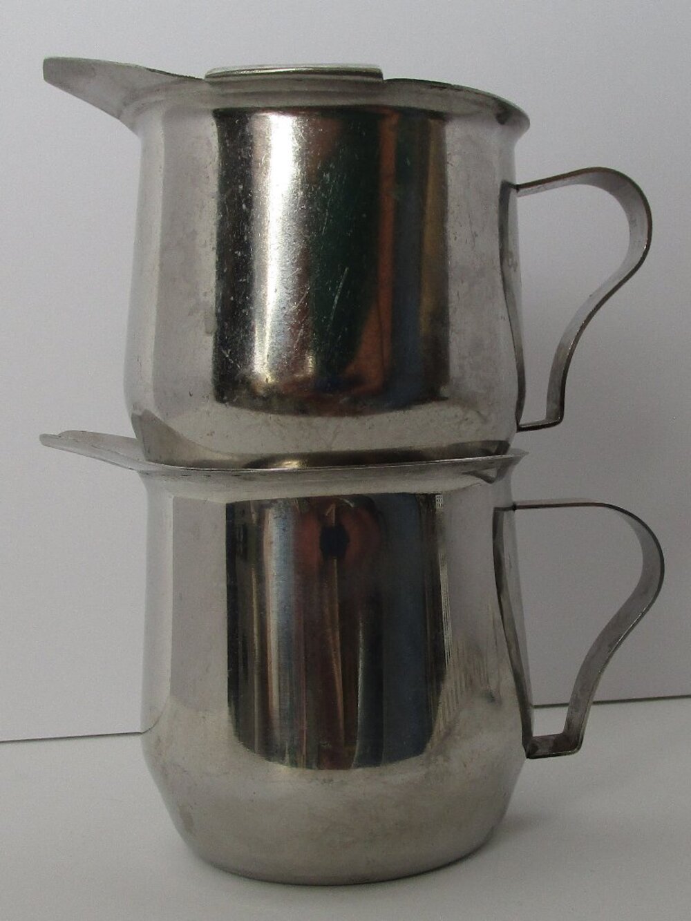 pair of stainless steel mini pitchers